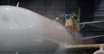 Image of workers spraying paint onto an aircraft
